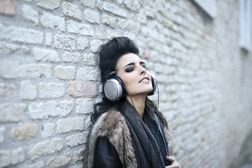 Woman wearing headphones, Music Heals: Mental Health Awareness Month